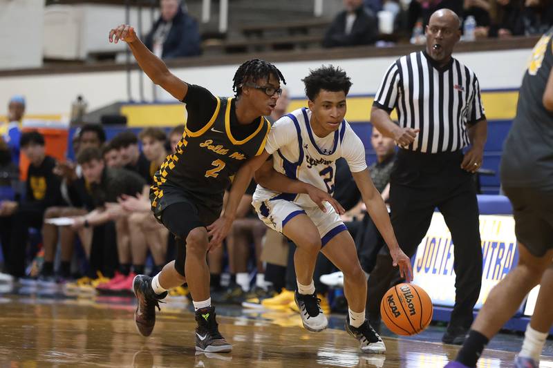 Joliet Central’s Kaden Henry works around Joliet West’s Elijah Wilson on Thursday, Jan. 15, 2026 in Joliet.