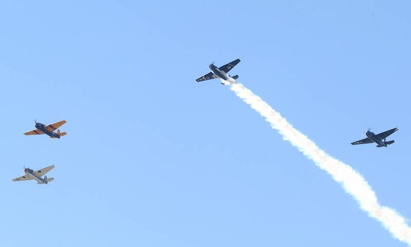 Four TBM aircrafts perform a Missing Man Formation above an American Flag during the 10th annual TBM Avenger Reunion and Airshow on Friday, May 16, 2025 at the Illinois Valley Regional Airport in Peru.