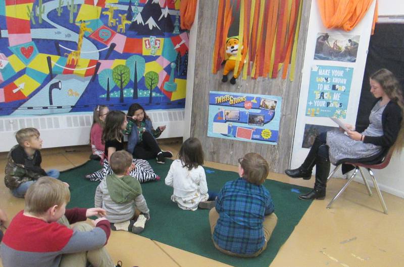 Plano Methodist Church Sunday school student are pictured with the puppet “Archie” and teacher Sera discussing the lesson and current events.