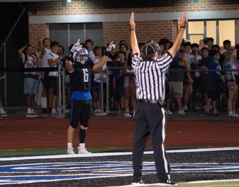 St. Charles North's Drew Surges (6) raises his arms in celebration after scoring his second touchdown of the game against Lake Zurich during a football game at St. Charles North High School on Friday, Sep 2, 2022.