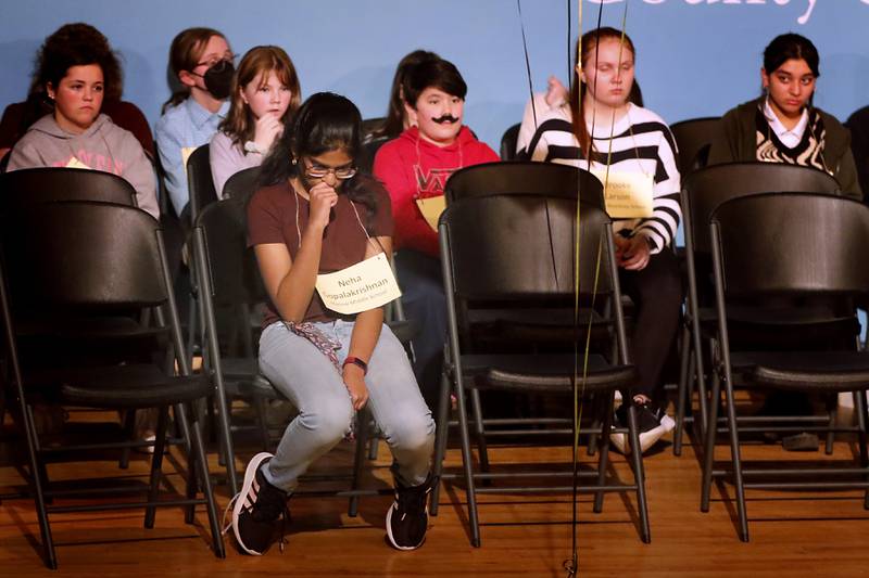 Neha Gopalakrishnan of Marlowe Middle School waits to see if she will get a another chance to spell another word after misspelling a word during the McHenry County Regional Office of Education 2023 Spelling Bee to look over some of the words on Wednesday, March 22, 2023, at McHenry County College's Luecht Auditorium in Crystal Lake.