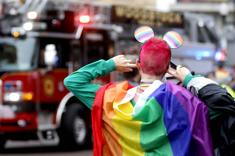 A parade goer plugs their ears as the Woodstock Fire Department takes part in the Woodstock PrideFest Parade Sunday, June 11, 2023, around the historic Woodstock Square.