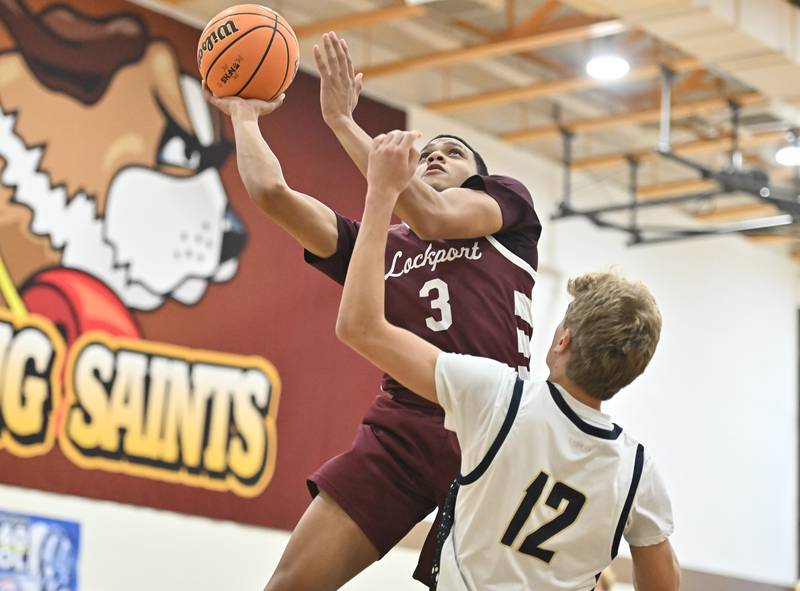 Lockport's Gavin Anderson soars over Lemont's Ryan Crane for a lay up during the WJOL tournament championship game on Saturday, NOV. 29, 2025, at Joliet.