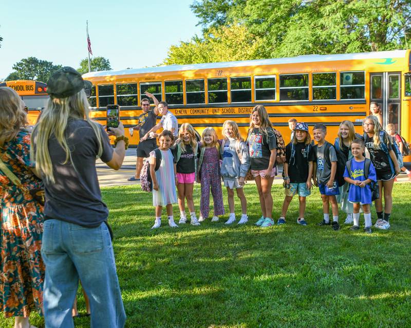 Students at Western Avenue Elementary School stop and take a photo after getting off the bus for the first day of school on Thursday Aug. 21, 2025, in Geneva.