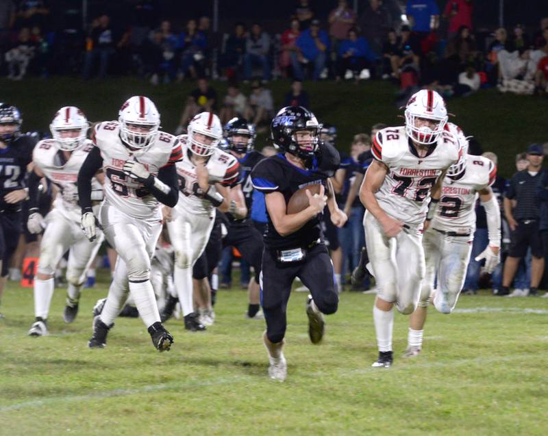 Eastland-Pearl City's Adam Awender (12) runs from Forreston defenders for a touchdown on Friday, Sept. 20, 2024 during NUIC Conference action in Pearl City.