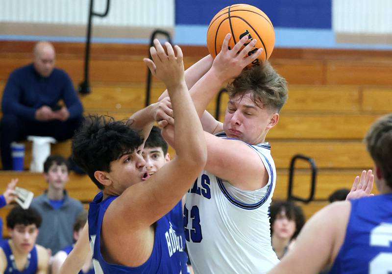 Hinckley-Big Rock's Luke Badal grabs a rebound in front of Rochelle Zell’s Guy Israel during their game Tuesday, Dec. 17, 2024, at Hinckley-Big Rock High School.