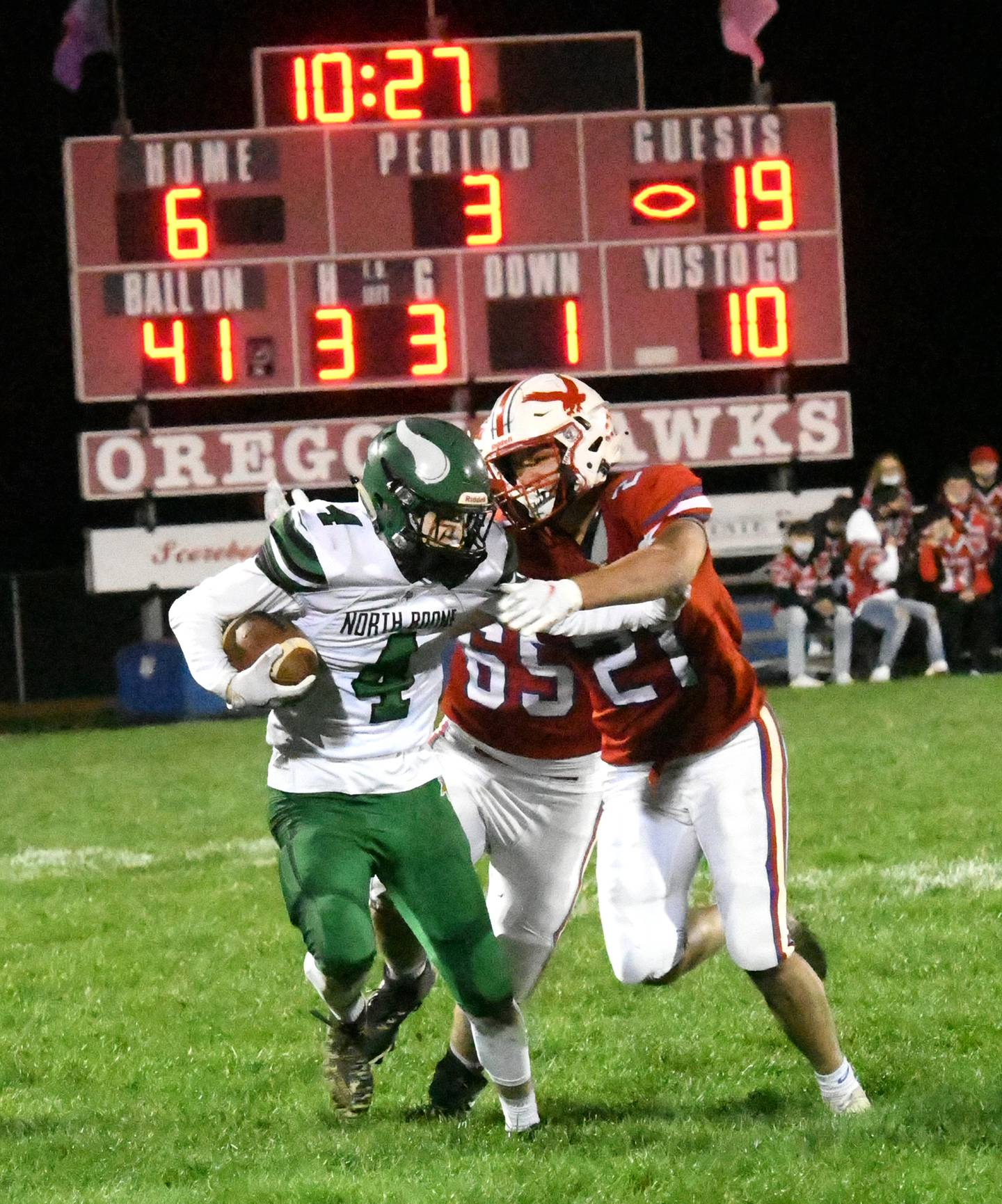 Oregon's Daniel Dominguez comes in to tackle North Boone's Chris Doetch Friday, April 9, 2021, at Landers Loomis Field.