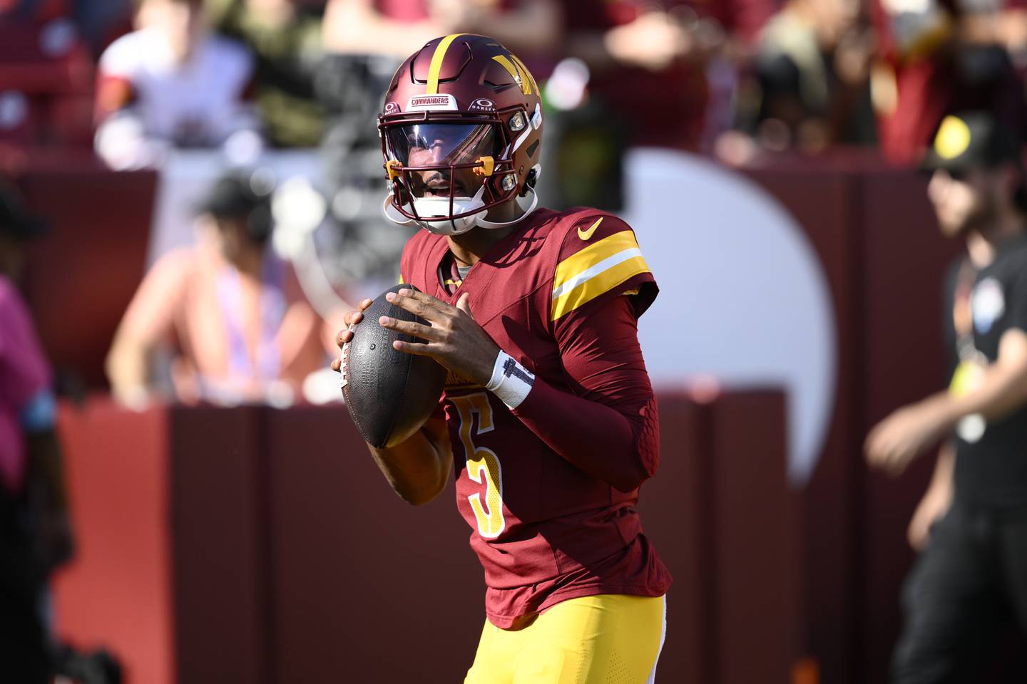 Washington Commanders quarterback Jayden Daniels (5) works out before an NFL football game against the Carolina Panthers, Sunday, Oct. 20, 2024, in Landover, Md. (AP Photo/Nick Wass)