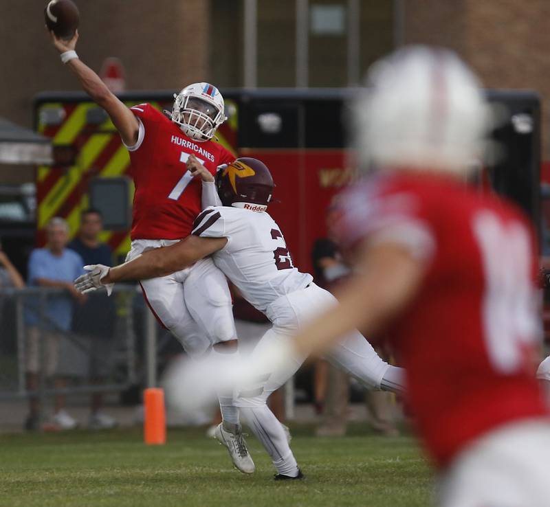 Richmond-Burton's Jeff Lehn hits Marian Central's Cale McThenia as McThenia throws a pass during a nonconference football game Friday, Aug. 25, 2023, at Marian Central Catholic High School.