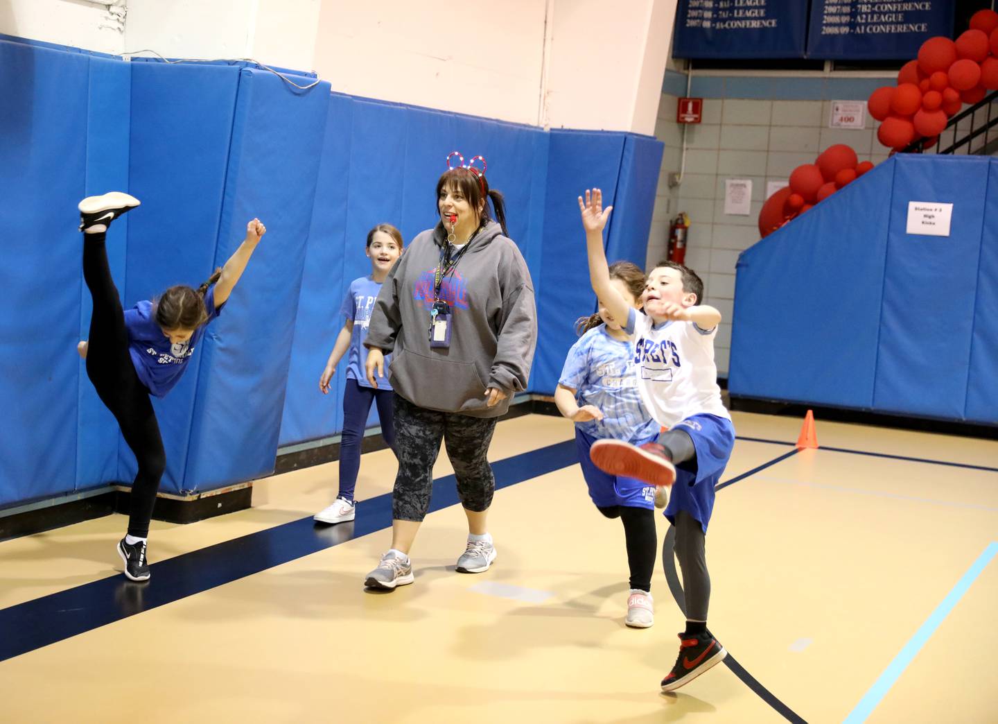 Physical education teacher Christine Giunta-Mayer laughs and dances with her students at St. Petronille Catholic School in Glen Ellyn.