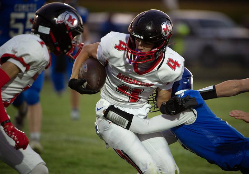 Momence's Jayden Dau, center, carries the ball on a play as Clifton Central's Bryce Denault, right, attempts to tackle in a game on Friday, September 5, 2025.