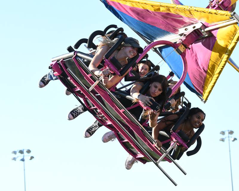 Madelyne Koehler, left, Isabella Saerno, center, and Enya Hrizak, all seniors at Oswego High School enjoy rides at PrairieFest Friday June 17, 2022 in Oswego.