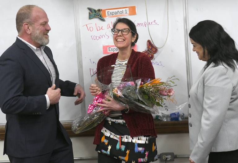 Oregon High School teacher Kimberly Radostits reacts for being chosen 2022 Illinois Teacher of the Year. Pictured with Radosttits is Oregon Superintendent Tom Mahoney (left) and State Superintendent of Education Dr. Carmen I. Ayala (right). Officials surprised Radostits in her classroom with the announcement on Tuesday morning.