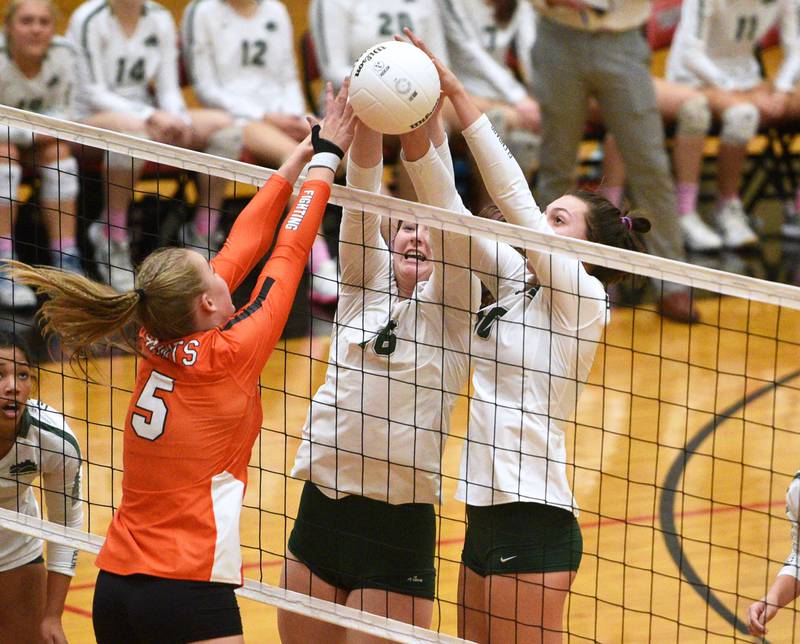 Paul Valade/pvalade@dailyherald.com
St. Charles East's Sarah Musial (5) battles at the net with Glenbard West's Breccan Scheck and Marin Johnson, right, during Monday’s Proviso West Class 4A girls sectional volleyball match in Hillside.
