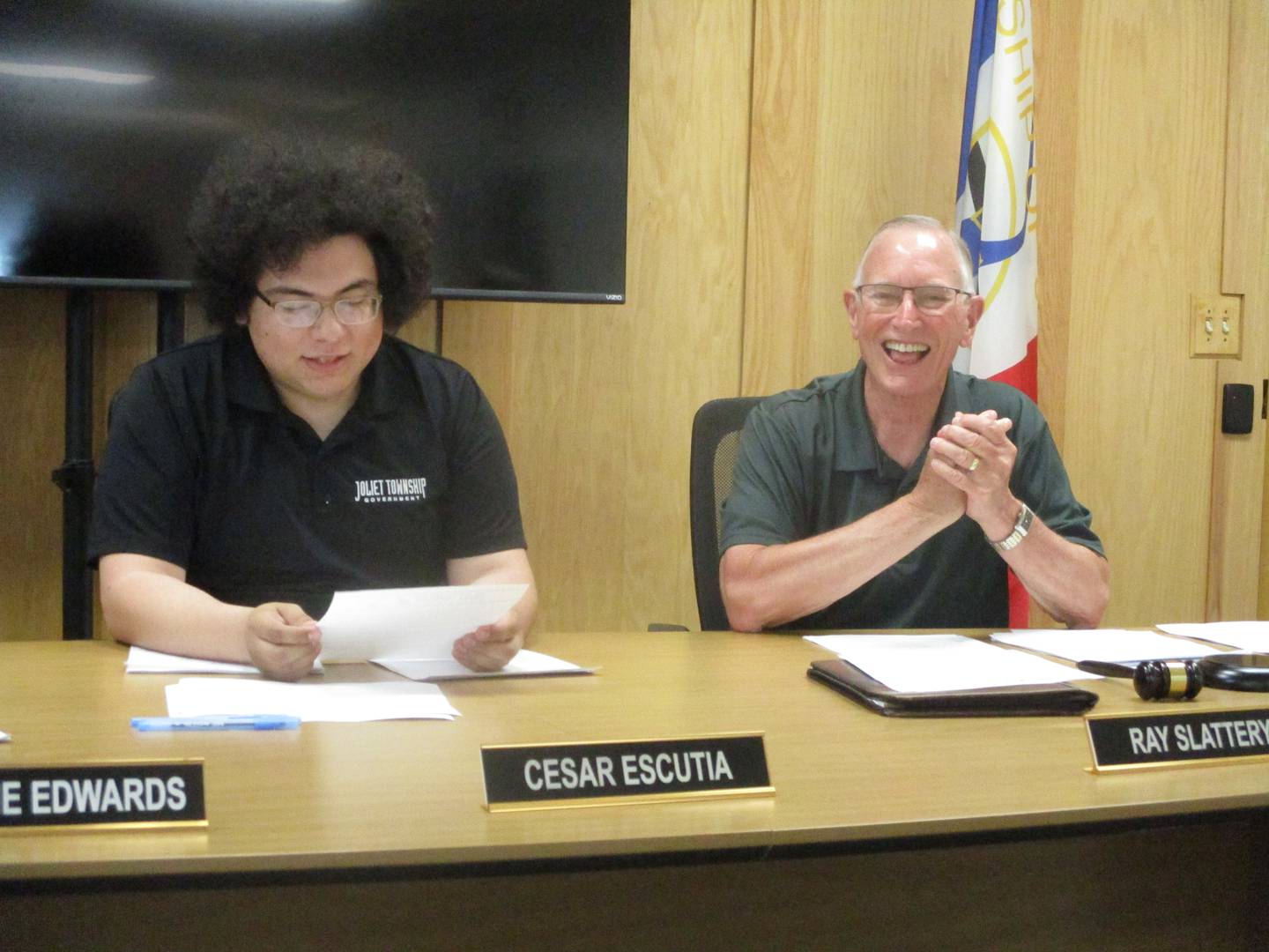 Joliet Township Trustee Cesar Escutia (left) talks about Trustee Ray Slattery (right) during their last township board meeting on Tuesday. May 13, 2025