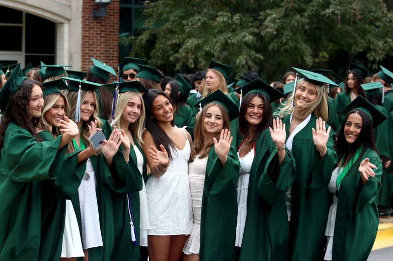 Members of the Class of 2025 pose for pictures during graduation at York High School in Elmhurst on Sunday, May 18, 2025.