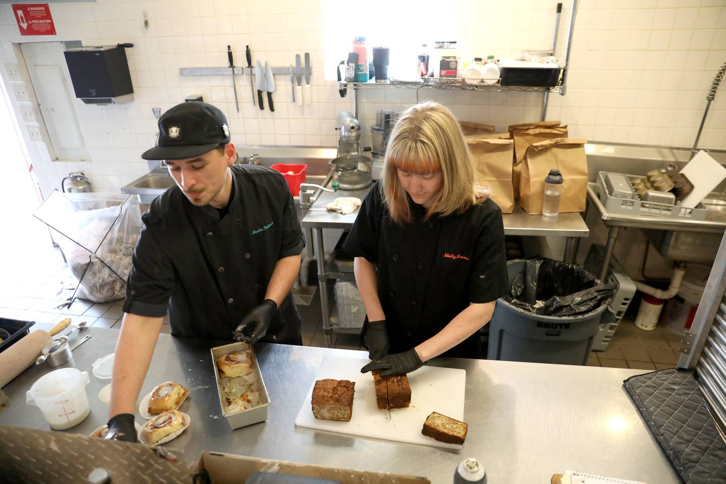 Bakers Austin Dabbert (left) of Wheaton and Molly Fraser (right) of Aurora joined the Corner Grind crew after both worked for Grahams 318 in Geneva, which closed in April.