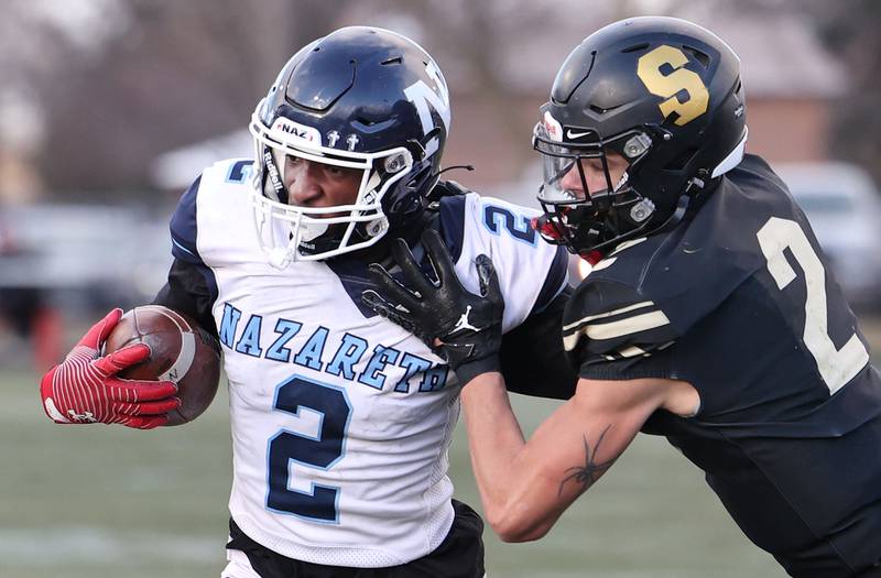 Nazareth's Justin Taylor is pushed out of bounds by Sycamore's Elijah Meier Saturday, Nov. 18, 2022, during their state semifinal game at Sycamore High School.