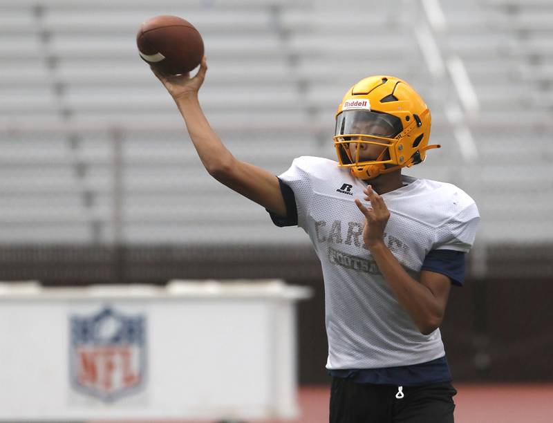 Carmel Catholic High School freshman quarterback Trae Taylor, a Crystal Lake resident, throws a pass during practice Monday Aug. 14, 2023’ at the school in Mundelein.