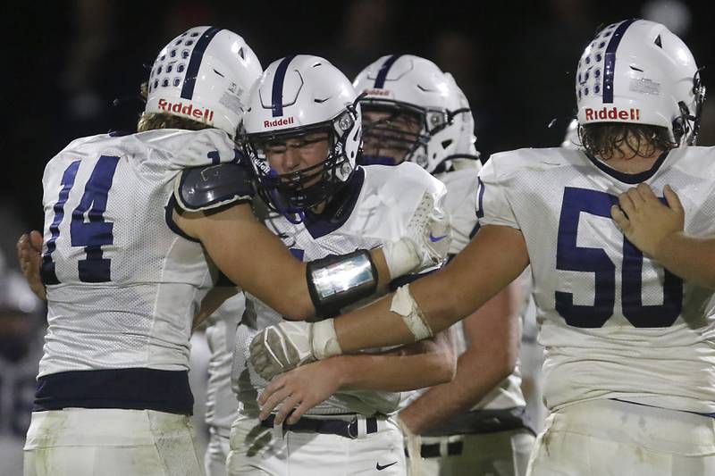 Cary-Grove's Ostin Hansen hugs \quarterback Peyton Seaburg as they come onto the field to run out the clock during a Fox Valley Conference football game on Friday, Sept. 27, 2024, at Prairie Ridge High School.
