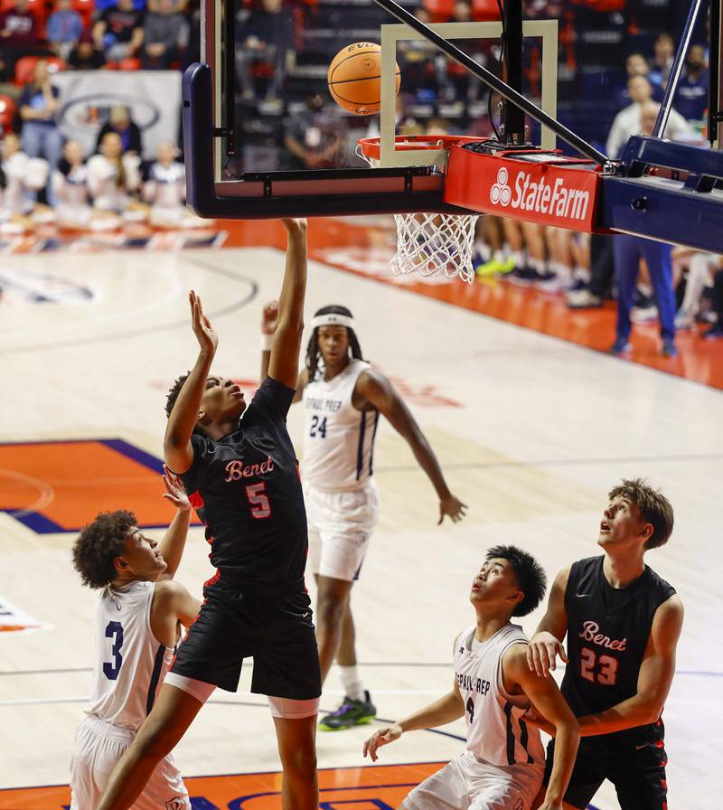 Benet's Perry Tchiegne (5) goes to the hoop past DePaul College Prep's AJ Chambers (3) during the IHSA Class 4A boys basketball state semifinal Friday, March 13, 2026 at the State Farm Center in Champaign.