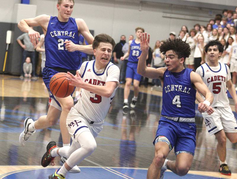 Burlington Central’s Caden West, right, keeps pace as Marmion Academy’s Collin Wainscott, left, drives in IHSA Class 3A Sectional title game action at Burlington Central High School Friday night.