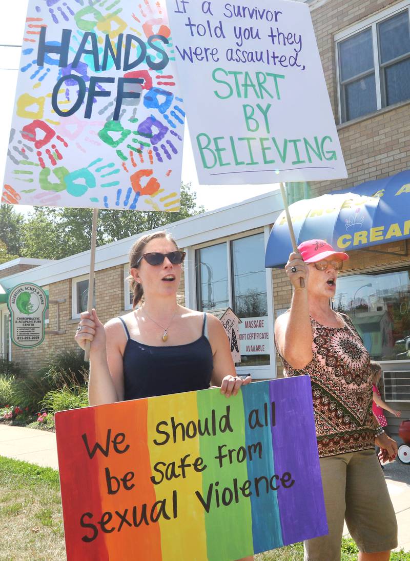 Kelsey Gettle, (left) of Sycamore, and her mom Kerry Mackenzie, from DeKalb, chant during a protest in front of Shawn's Coffee Shop in Sycamore. Protesters were marching Friday to inform the public of allegations that the owner, Shawn Thrower, committed misdemeanor battery against a 15-year-old employee. Thrower allegedly bit and inappropriately touched the employee.