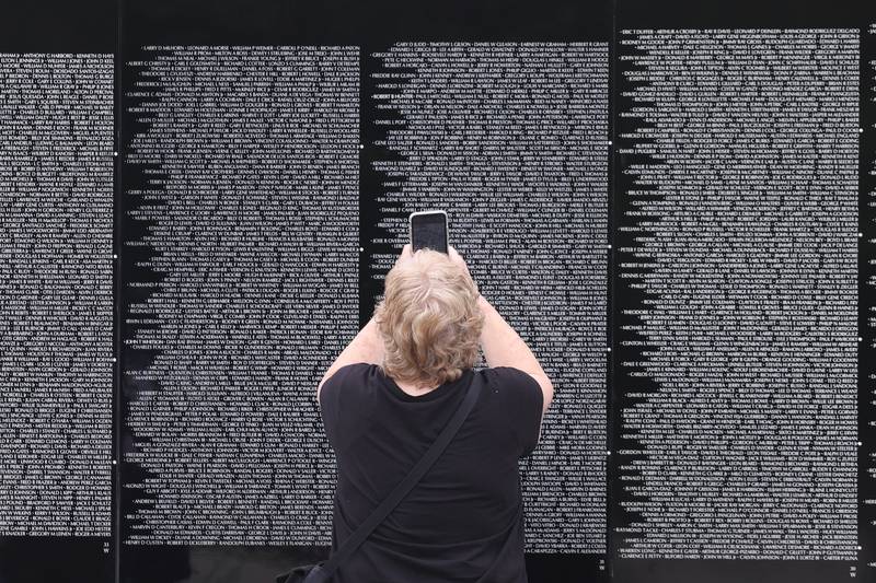 A person takes a photo of a name on the Vietnam Moving Wall on Saturday, July 1st, 2023, in Manhattan.