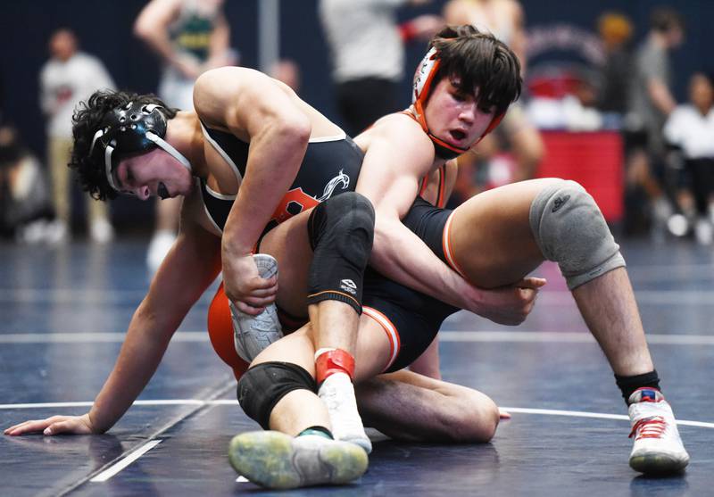 DeKalb’s Jacob Luce, left, and St. Charles East’s Anthony Gutierrez compete in the 165-pound final during the Class 3A Conant wrestling sectional on Saturday, Feb. 10, 2024 in Hoffman Estates.