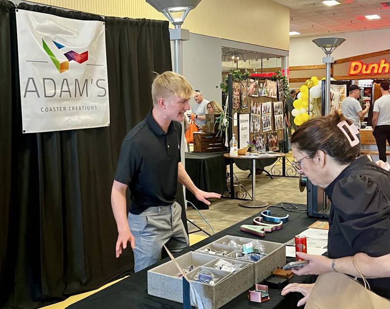 Eastland High School senior Adam Awender greets customers at his business, Adam's Coaster Creations, in Sterling's Northland Mall at the Whiteside Area Career Center's CEO program student trade show on April 23, 2025.