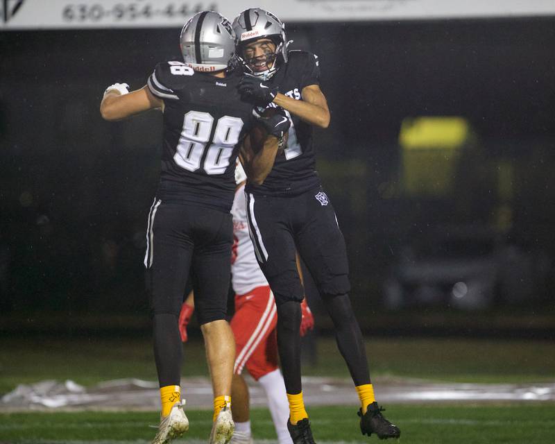 Kaneland's Ryan Majerus (88) and Evan Frieders (1) celebrate a touchdown against Ottawa on Friday, Sept. 19, 2025 in Maple Park.