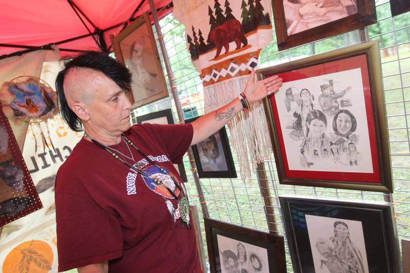 Tih Kobolson, of Kenosha, Wis., with Bears Den Artistry, features her pencil drawing which includes all stages of a woman's life as a Native American during the 30th Annual Potawatami Trails Pow-Wow at Shiloh Park on Saturday, August 26th in Zion. 
Photo by Candace H. Johnson for Shaw Local News Network