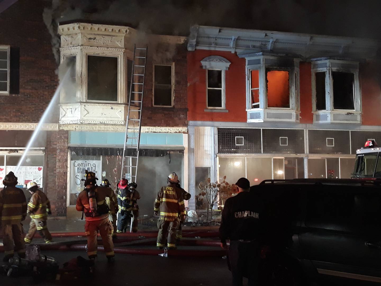 Firefighters work to contain a fire in downtown Mendota on Friday, Dec. 30, 202w.