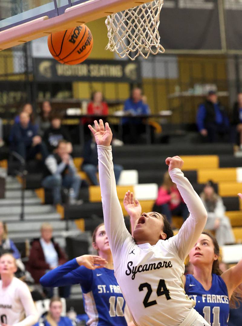 Sycamore's Monroe McGhee gets to the basket in front of St. Francis' Natalie Doyle during their game Thursday, Jan. 4, 2023, at Sycamore High School.
