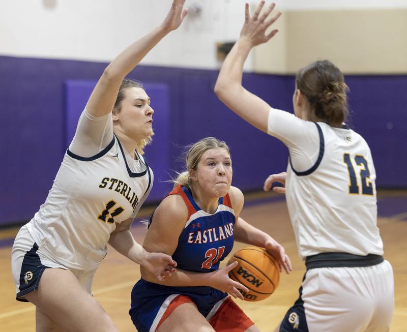 Eastland’s Olivia Klinefelter handles the ball against Sterling’s Natalie Eddinger (left) and Macie Lofgren Thursday, Dec. 26, 2024, during the Dixon Girls Holiday Basketball Tournament.