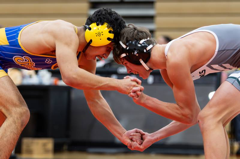 Joliet Central's Isaiah Kan takes on Nick Polzin of Plainfield East in the 144-pound match at Plainfield East on Dec. 12, 2024.