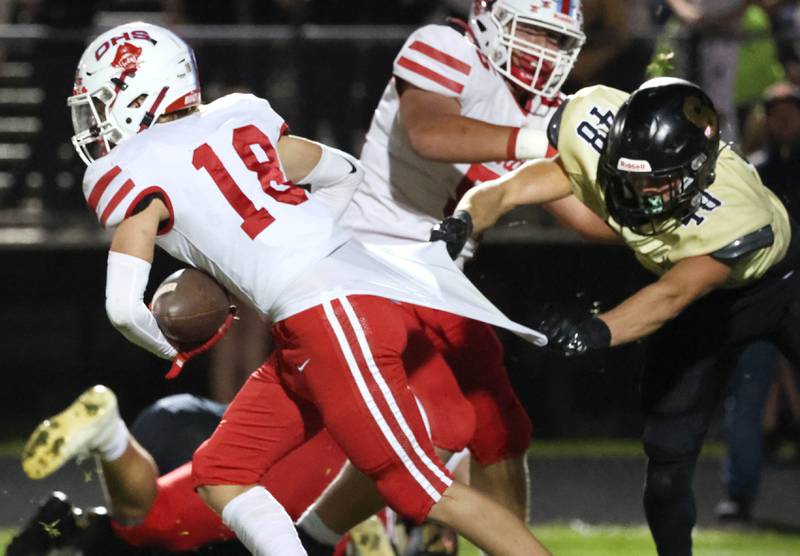 Sycamore's Vincent Pitstick tries to hold on to Ottawa's Jack Pongracz during their game Friday, Sept. 27, 2024, at Sycamore High School.
