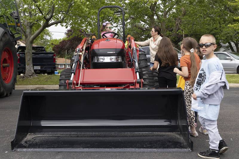 Franklin School kindergarteners explore a tractor Thursday, May 9, 2024 on display from Birkey’s of Prophestown during the 2024 Sterling High School FFA Farmapalooza.