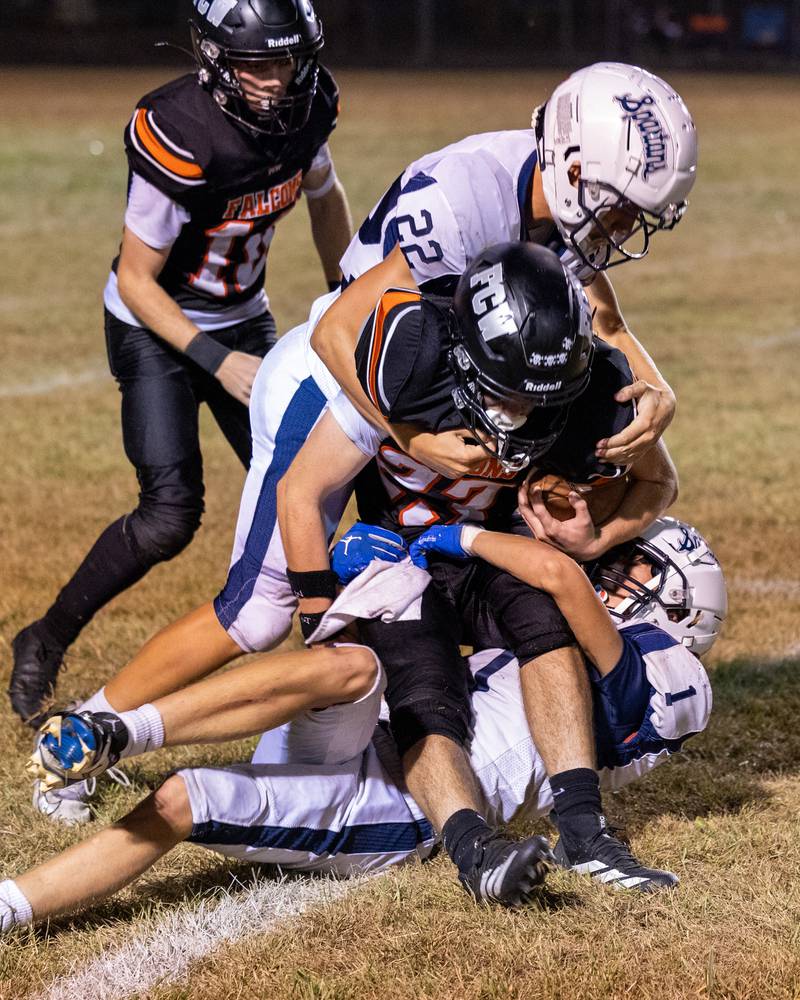 Brezdyn Simons (23) is brought down by Ridgewood’s defense on Friday, Sept. 26, 2025, at Woodland School in rural Streator.