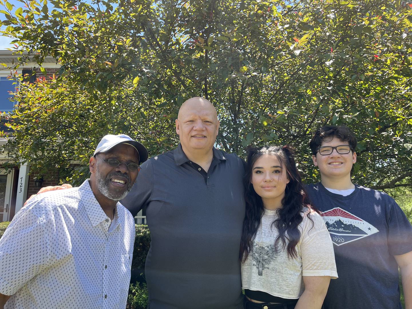 Tab Martin (left) standing with Antonio Rivera and his children, Angelina Rivera and T.J. Rivera, outside of their homes on Thursday, June 30, 2022 in Bolingbrook.