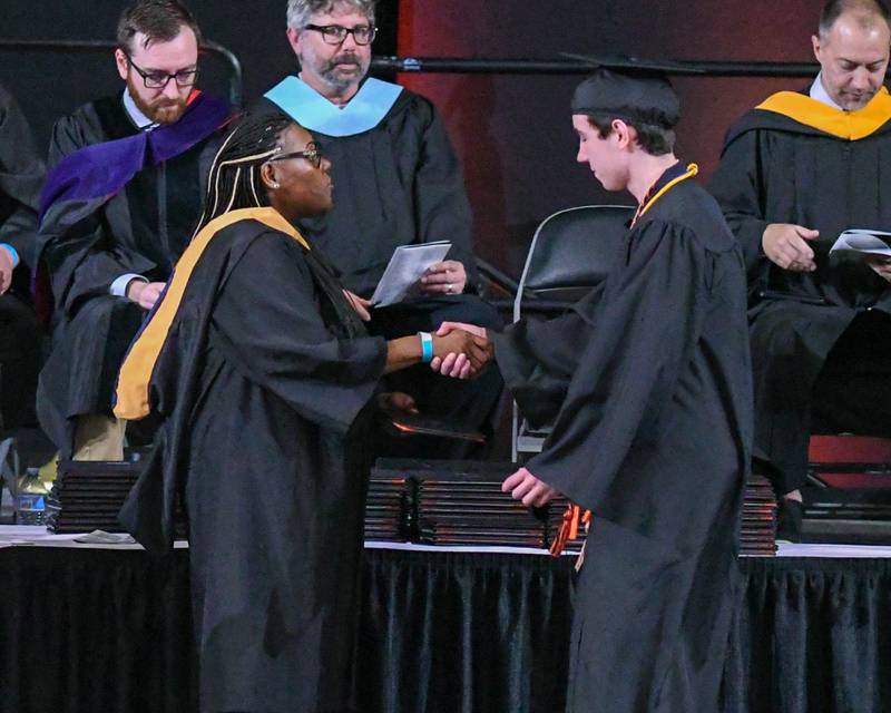 DeKalb High School senior Logan Heffernan receives his diploma on Saturday, May 24, 2025, during the Class of 2025 Commencement ceremony held at the Convocation Center in DeKalb.