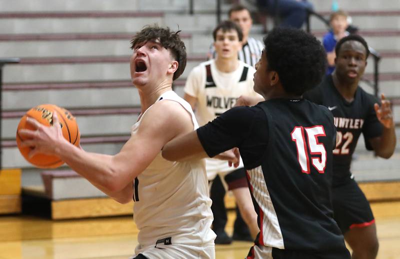 Prairie Ridge's Elijah Loeding tries to drive to the basket against Huntley's Isaac Muze during a Fox Valley Conference boys basketball game on Wednesday, Jan. 21, 2026, at Prairie Ridge High School in Crystal Lake.