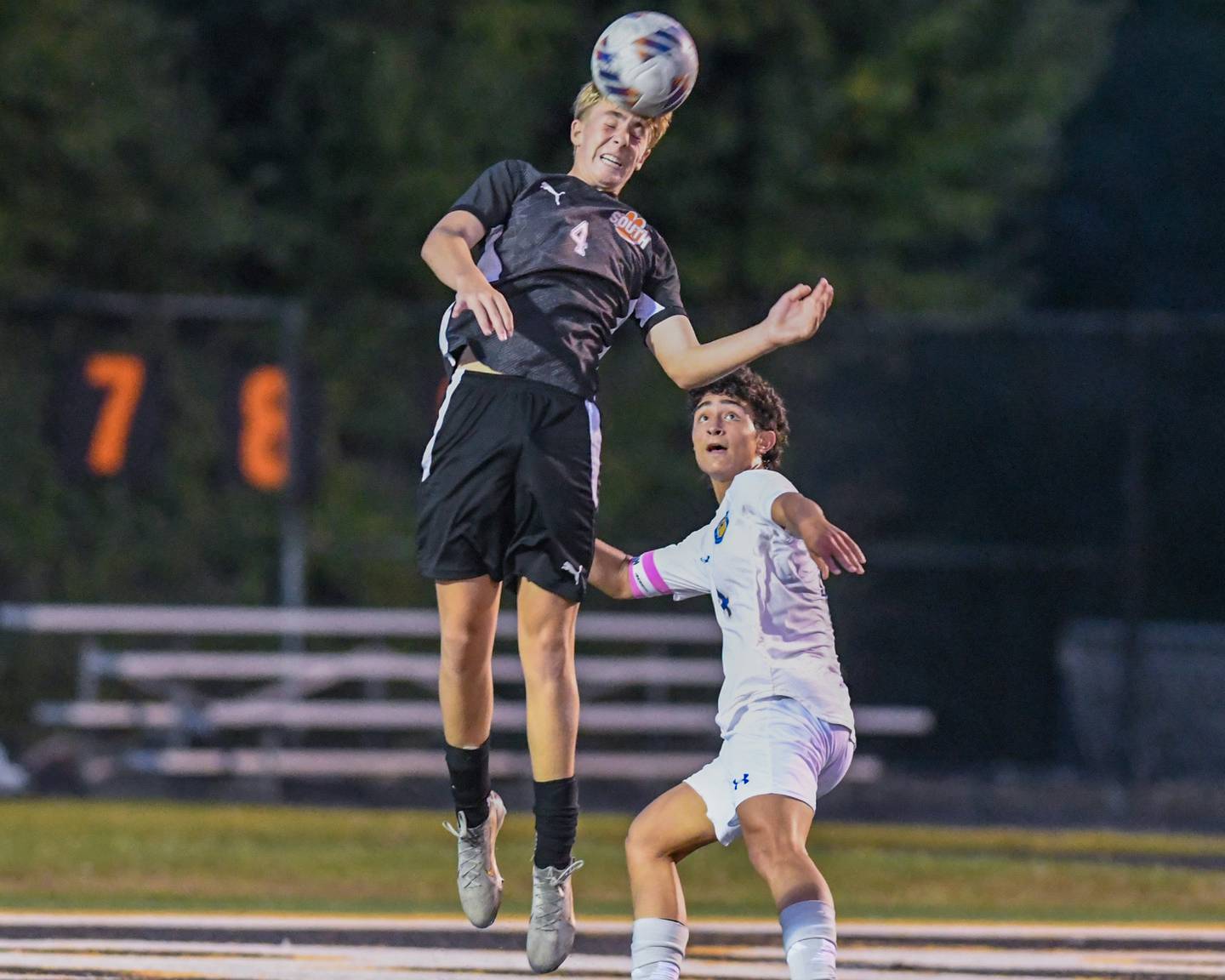 Wheaton Warrenville South's Alex Waterman (4) heads the ball while being defended by Wheaton North's Michael Shebar (4) during the game on Thursday Sept. 11, 2025, held at Wheaton Warrenville South.