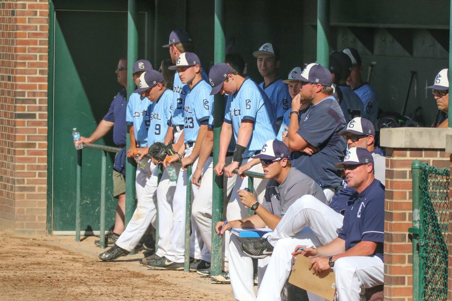 The Plainfield South baseball team watches a game together.