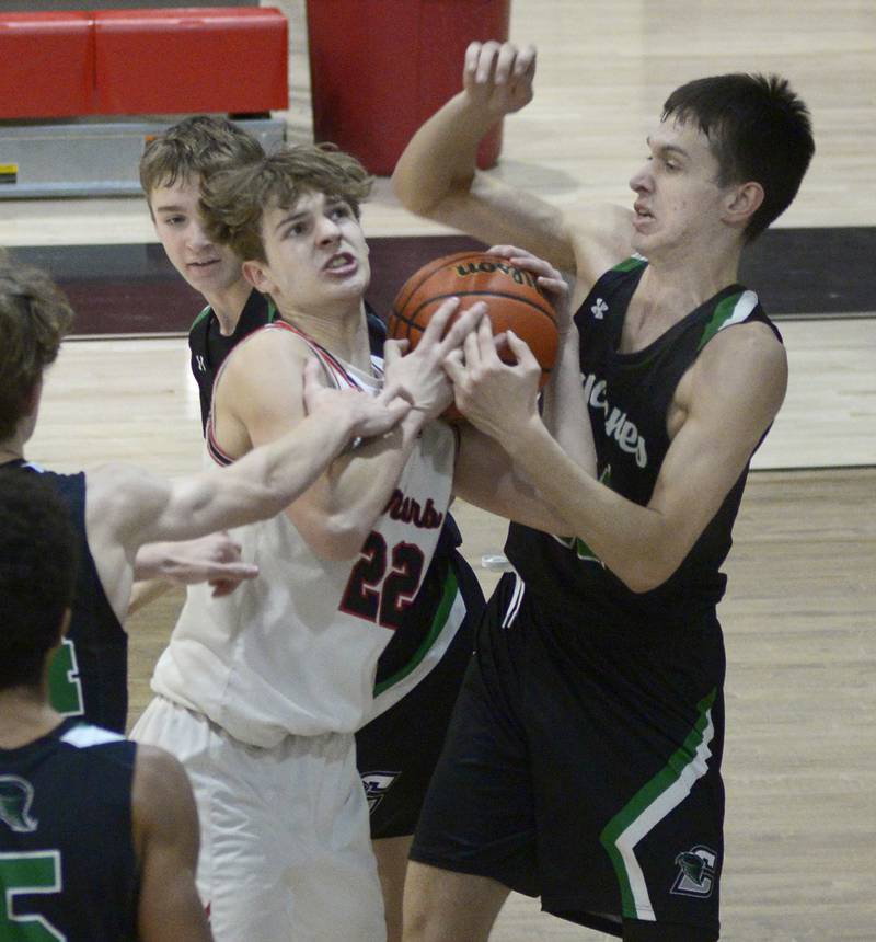 Woodland’s Zander Radke fights for a rebound with Cornerstone Christian’s Josh Kalmes Monday in the 2nd period at Woodland