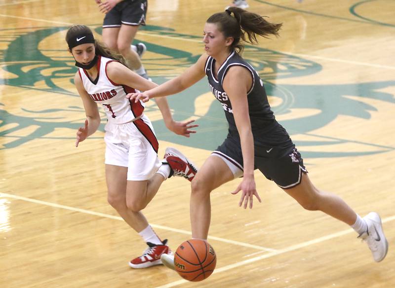 Prairie Ridge's Karsen Karlblom pushes the ball up the court against the defense of Deerfield's Nikki Kerstein during a IHSA Class 3A Grayslake Central Sectional semifinal basketball game Tuesday evening, Feb. 22, 2022, between Prairie Ridge and Deerfield at Grayslake Central High School.