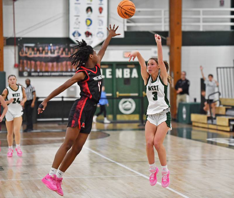 Glenbard West’s Lily Hubbuch (3) shoots and scores three points over Mundelein’s Grace Dunigan during a Grow the Game Showcase game on January 2, 2026 at Glenbard West High School in Glen Ellyn.