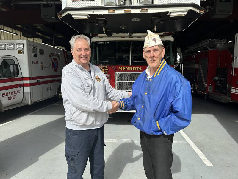 Bill Bradford (right) from the Catholic War Veterans handed off a check for $1,000 to Mendota Fire Chief Dennis Rutishauser for the Mendota Fire Department to purchase new extrication equipment.