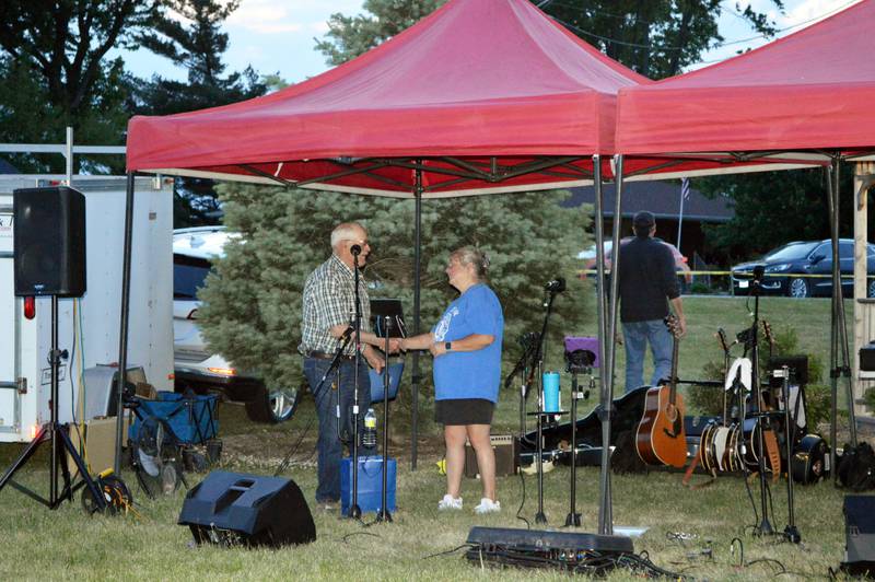 Laura Werner, right, is presented the Leaf River Grange No. 1812 Citizen of the Year award by Tom Snodgrass on June 2, 2023, during Leaf River Summer Daze. "She offers to help, and shows up when there is a job to be done, and then does it with a good attitude and smile," Snodgrass said of Werner.