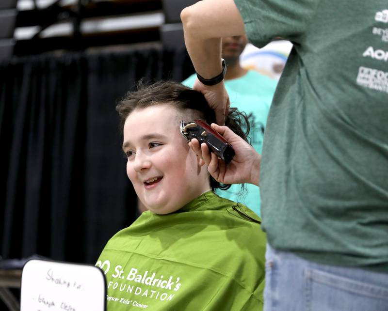 Myles Clesen, 10, has his head shaved by Nicole Walke during the St. Charles Challenge fundraiser for the St. Baldrick’s Foundation on Friday, March 15, 2024 at St. Charles East High School.